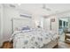 Bright main bedroom with large sliding door backyard access, a ceiling fan, and a white dresser at 4204 Saltwater Blvd, Tampa, FL 33615