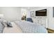 Comfortable main bedroom featuring a full bed, dresser with a tv, and view into hallway at 4204 Saltwater Blvd, Tampa, FL 33615