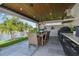Outdoor dining area featuring wood ceilings and outdoor kitchen at 4204 Saltwater Blvd, Tampa, FL 33615