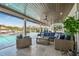 Covered outdoor patio features stylish seating and views of the pool and waterfront at 4204 Saltwater Blvd, Tampa, FL 33615
