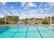 Stunning pool overlooking the water, surrounded by a screened enclosure and beautiful views of the canal at 4204 Saltwater Blvd, Tampa, FL 33615