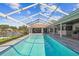 Inviting screened-in pool area with a clear blue swimming pool, outdoor dining, and waterfront views at 4204 Saltwater Blvd, Tampa, FL 33615
