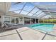 Inviting screened pool area with comfortable lounge chairs and a spacious patio perfect for relaxing and entertaining guests at 4204 Saltwater Blvd, Tampa, FL 33615