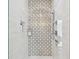Modern tiled walk-in shower with a decorative accent wall and built-in shelving for toiletries at 4204 Saltwater Blvd, Tampa, FL 33615