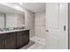Bathroom showcasing a dual sink vanity with granite countertop and tiled stand up shower at 4424 Tuscan Loon Dr, Tampa, FL 33619