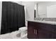 Bathroom with dark wood cabinets, granite countertops, and shower with dark curtain at 4424 Tuscan Loon Dr, Tampa, FL 33619