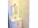 Bathroom vanity with olive branch wallpaper creating a stylish and inviting space at 4485 49Th N Ave, St Petersburg, FL 33714