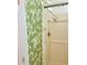 Shower stall featuring tropical patterned wallpaper creating a serene and vibrant bathroom setting at 4485 49Th N Ave, St Petersburg, FL 33714