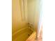 Vintage yellow bathtub with classic fixtures, adding charm to the home's bathroom at 4485 49Th N Ave, St Petersburg, FL 33714