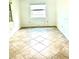 Bright bedroom featuring diamond patterned flooring and a window letting in natural light at 4485 49Th N Ave, St Petersburg, FL 33714