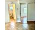Hallway displaying the transition from tile to wood flooring with bathroom and bedroom entries at 4485 49Th N Ave, St Petersburg, FL 33714
