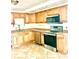 Bright kitchen featuring stainless steel appliances, wood cabinets, and tile flooring at 4485 49Th N Ave, St Petersburg, FL 33714