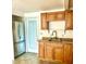 Kitchen featuring stainless steel refrigerator, wood cabinets, and neutral countertops at 4485 49Th N Ave, St Petersburg, FL 33714