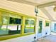 Bright sunroom featuring large windows and a ceiling fan at 4485 49Th N Ave, St Petersburg, FL 33714
