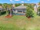 Aerial view of the screened-in pool in the backyard with mature landscaping at 4826 68Th Street E Cir, Bradenton, FL 34203