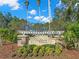 The Reserve at Crossing Creek entrance sign with lush landscaping and palm trees on a sunny day at 4826 68Th Street E Cir, Bradenton, FL 34203