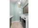 Well-lit laundry room featuring a washer, dryer, counter, and overhead cabinets at 4826 68Th Street E Cir, Bradenton, FL 34203
