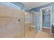 Bathroom featuring tiled walk-in shower, bench and walk-in closet entrance at 4826 68Th Street E Cir, Bradenton, FL 34203