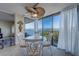 Bright dining area with water views featuring stylish seating and a modern fan above a glass-topped table at 500 N Osceola Ave # 609, Clearwater, FL 33755