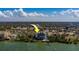Elegant condo building with waterfront views and access to a pool, surrounded by lush trees and vegetation at 500 N Osceola Ave # 609, Clearwater, FL 33755