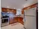 Functional kitchen features classic wood cabinetry, stainless steel appliances, tile backsplash, and plenty of storage at 500 N Osceola Ave # 609, Clearwater, FL 33755
