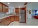 Bright kitchen shows stainless steel refrigerator, tile backsplash, lots of cabinet space and an opening to the living area at 500 N Osceola Ave # 609, Clearwater, FL 33755