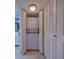 Convenient laundry area with a stacked washer and dryer, neatly tucked away behind white louvered doors at 500 N Osceola Ave # 609, Clearwater, FL 33755