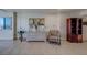 Neutral living area featuring tile floors, a dresser with decor, plaid chair, and a decorative hutch at 500 N Osceola Ave # 609, Clearwater, FL 33755