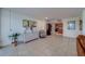 Spacious living area featuring tile floors, light walls, decor, and view into the kitchen, dining, and balcony at 500 N Osceola Ave # 609, Clearwater, FL 33755
