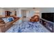 Spacious living room offering ample seating, a glass table, and an entertainment center with a large TV at 500 N Osceola Ave # 609, Clearwater, FL 33755