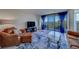 Well-appointed living room with comfortable seating, glass table, and access to a balcony with water views at 500 N Osceola Ave # 609, Clearwater, FL 33755