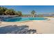 Community pool overlooks bay waters with lush palm trees and bay views at 500 N Osceola Ave # 609, Clearwater, FL 33755