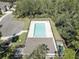 Aerial shot showcases the community pool with surrounding lounge chairs and privacy fence at 5104 2Nd E Ave, Palmetto, FL 34221