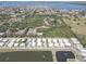 Aerial view of the neighborhood with a pond, mature trees and water fountains in the pond at 5104 2Nd E Ave, Palmetto, FL 34221