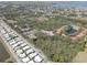 This aerial view shows the neighborhood, mature trees, a pond, and the ocean in the distance at 5104 2Nd E Ave, Palmetto, FL 34221