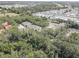 This beautiful aerial view shows lush, mature trees, a pond, and easy access to stores at 5104 2Nd E Ave, Palmetto, FL 34221