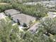 An aerial view shows a lovely home with a well-manicured lawn, mature trees and a paved drive at 5104 2Nd E Ave, Palmetto, FL 34221
