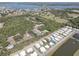 A lush aerial view shows a community, a retention pond and mature trees, with water in the distance at 5104 2Nd E Ave, Palmetto, FL 34221