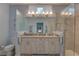 Bright bathroom with double sinks, quartz countertops, and a glass shower at 5104 2Nd E Ave, Palmetto, FL 34221