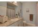 Bathroom featuring granite countertops, decorative mirror, and shower with curtain at 5104 2Nd E Ave, Palmetto, FL 34221