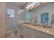 Bright bathroom with double sinks, quartz countertops, and a window at 5104 2Nd E Ave, Palmetto, FL 34221