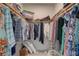 Large walk-in closet with built-in wooden shelving and hanging racks at 5104 2Nd E Ave, Palmetto, FL 34221