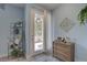 Stylish foyer with light blue walls, decor shelving, and beautiful furnishings at 5104 2Nd E Ave, Palmetto, FL 34221