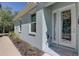 Charming front entrance with a decorative wreath, glass door, and well-maintained landscaping at 5104 2Nd E Ave, Palmetto, FL 34221