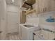 Well-lit laundry room with modern washer and dryer and convenient utility sink at 5104 2Nd E Ave, Palmetto, FL 34221