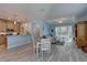 Bright, open living space featuring kitchen, dining area, and living room with wood flooring and light blue walls at 5104 2Nd E Ave, Palmetto, FL 34221