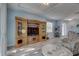 Living space with wood flooring, light blue walls, furniture, and a large entertainment center at 5104 2Nd E Ave, Palmetto, FL 34221