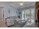 Living space with wood flooring, light blue walls, furniture, and sliding glass doors at 5104 2Nd E Ave, Palmetto, FL 34221