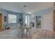 View of light blue living space with wood floors, dining area, entrance to bathroom and bedroom at 5104 2Nd E Ave, Palmetto, FL 34221