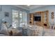 Spacious living space with wood flooring, light blue walls, furniture, and sliding glass doors to a screened porch at 5104 2Nd E Ave, Palmetto, FL 34221